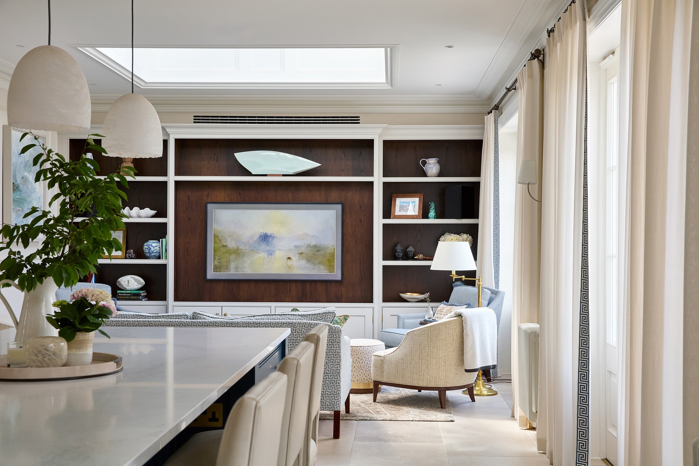 Modern kitchen and living room with sheer curtains with striking Greek key border, by Max Buston