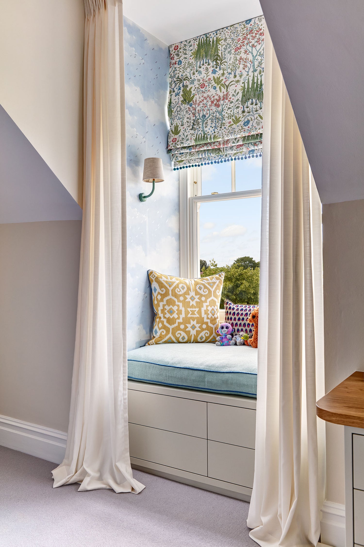 cozy nook showing window seat and curtains in mansard window