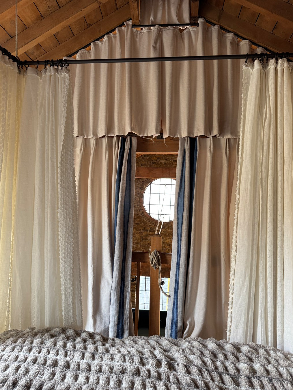 Detail showing tented curtain scheme with four poster bed