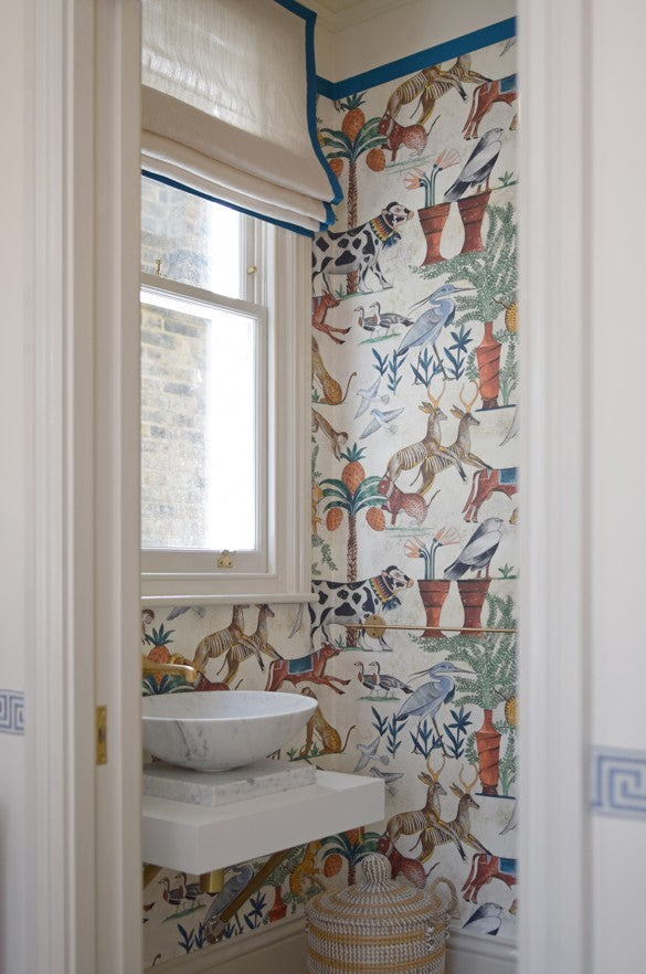 Bathroom with colourful animal wallpaper and sheer roman blind