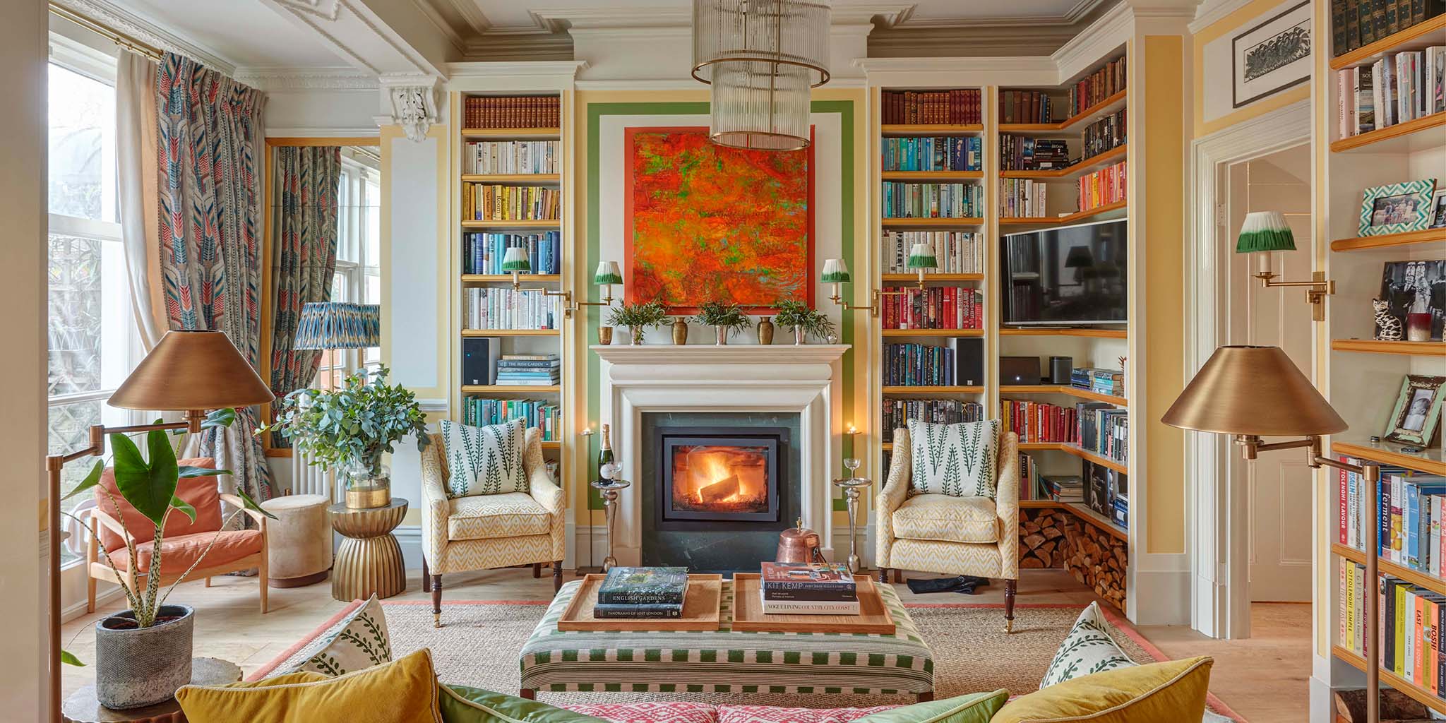 Colourful and dramatic living room with yellows, greens and coral by Max Buston. With layered curtains in the window.