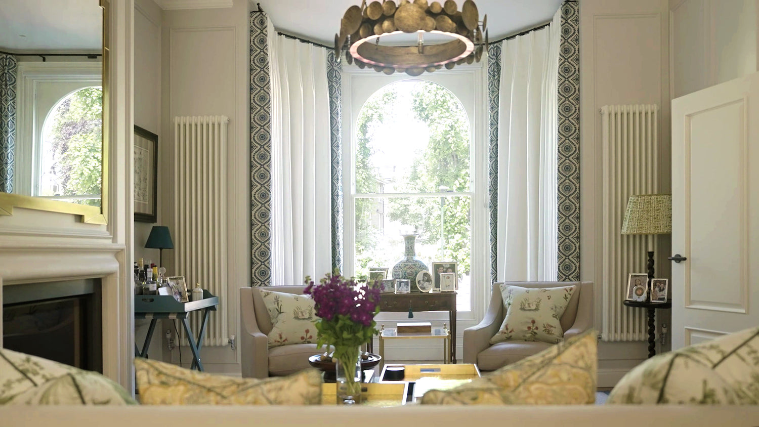 Richmond Drawing room with white linen curtains and embroidered blue border. Fabrics by Pierre Frey and Fabricut.