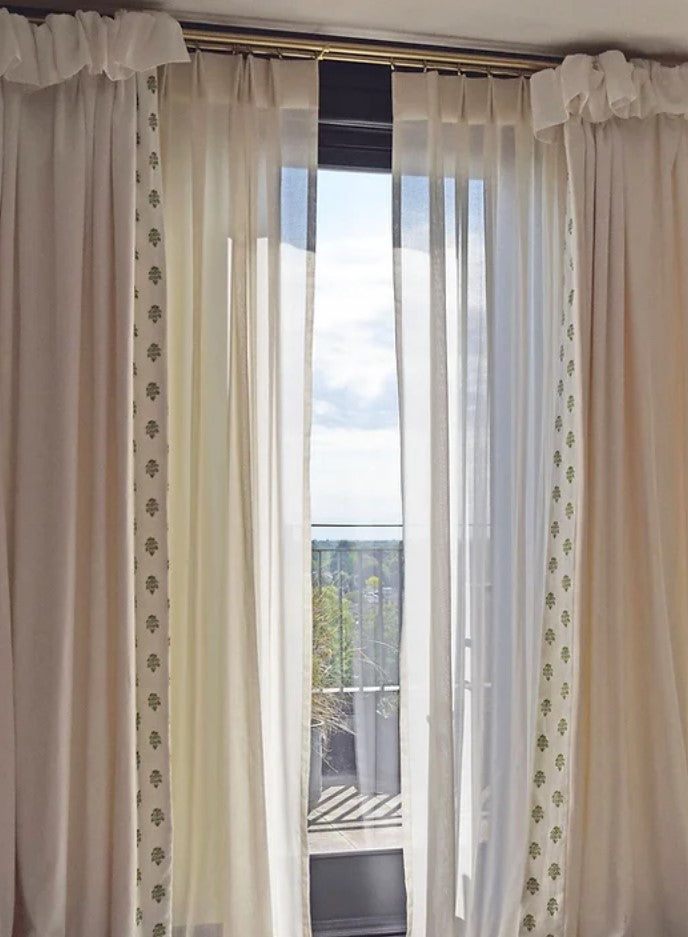 Sheer curtains with cape heading and tailored pleat heading on brass poles