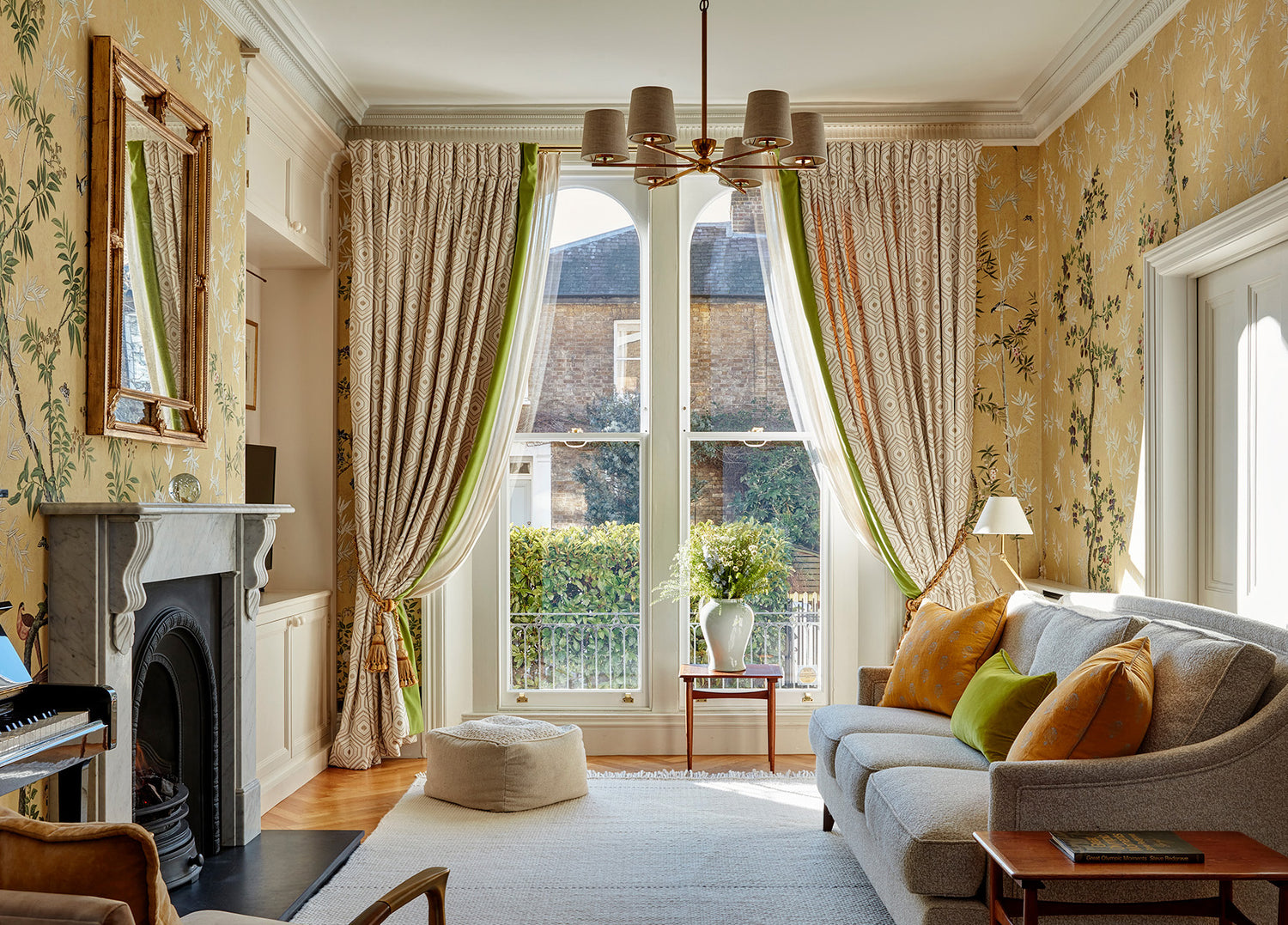 Grand geometric embroidered curtains with green velvet border and layered sheers in this West London home.