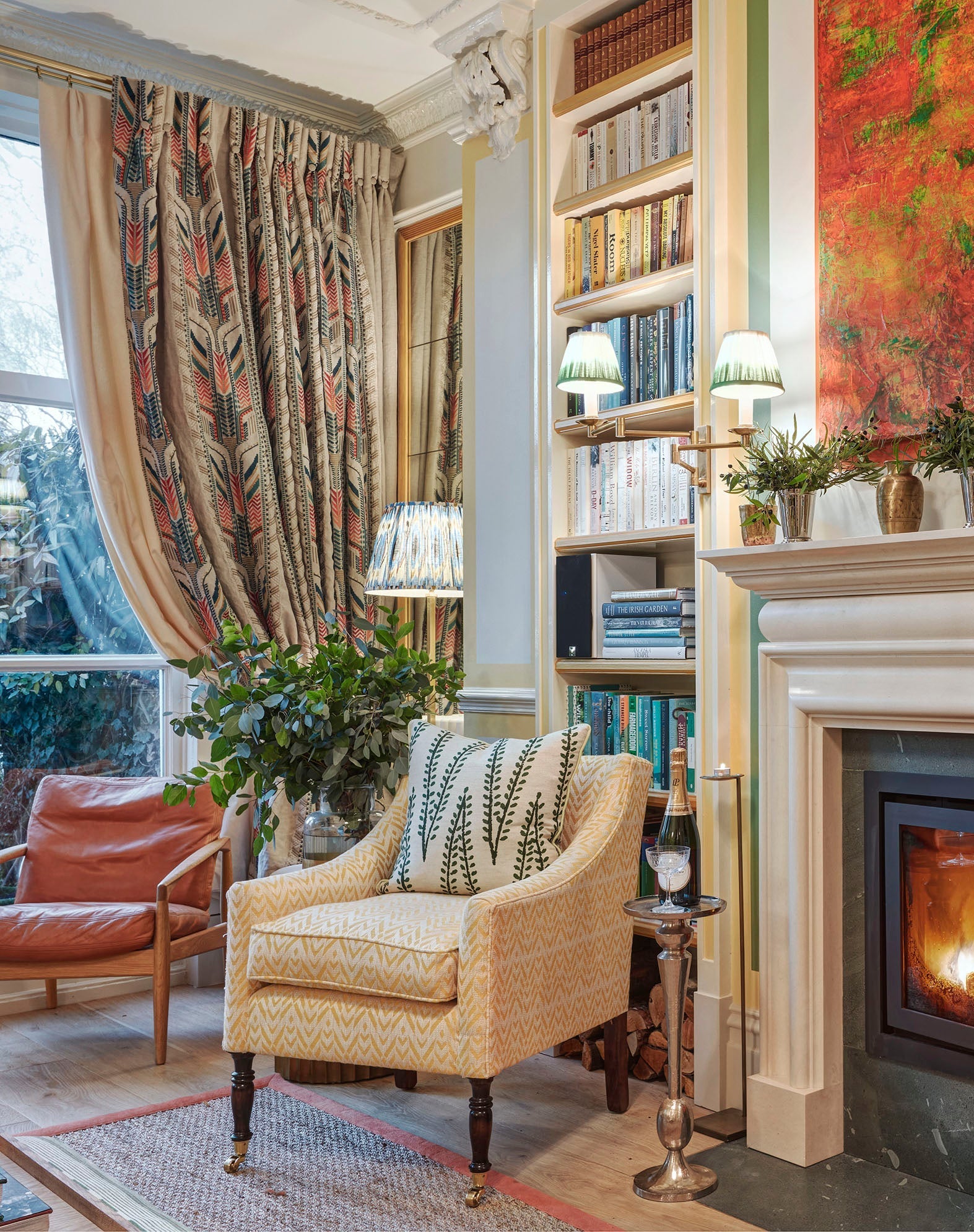 A colourful living room with striking embroidered curtains in the window