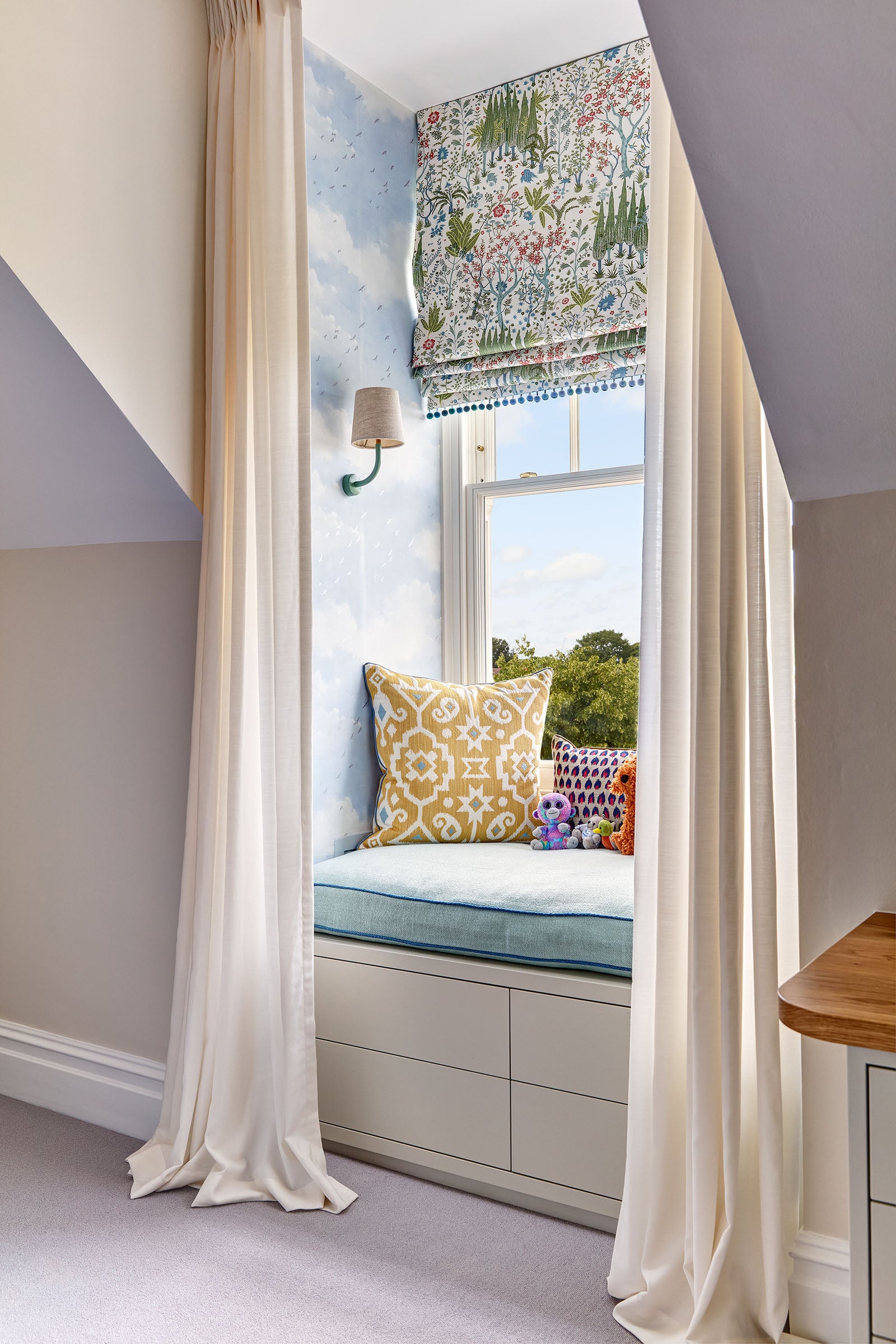 cozy nook showing window seat and curtains in mansard window